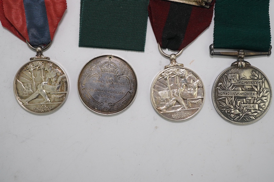 Four assorted Service medals; Vict unnamed Volunteer Long Service medal; GV Colonial Auxiliary Forces Long Service medal (disc only) to E.S.Ware; ERII ISM to Thomas Edward Downes; ERII ISM to William Henry Sharratt. Cond